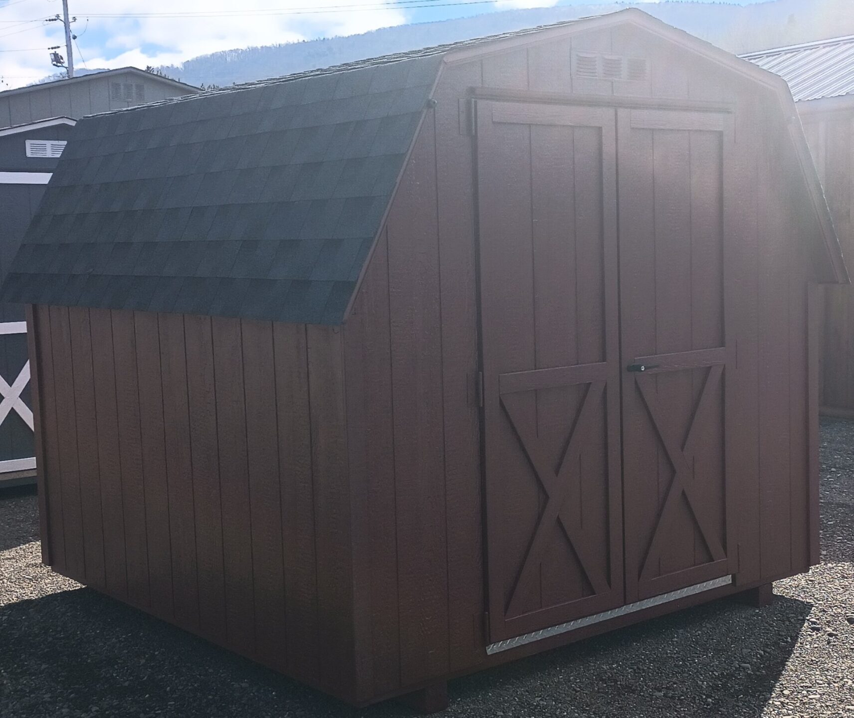 Red on red wall barn with charcoal shingles and double doors
