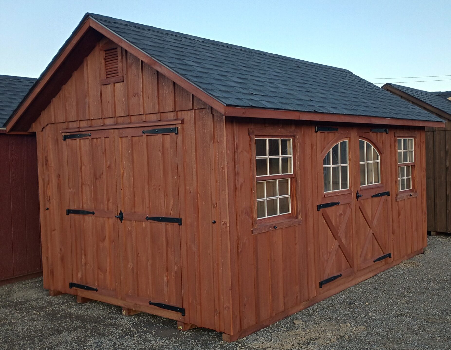 Board and batten shed with double doors and single carriage door with two windows