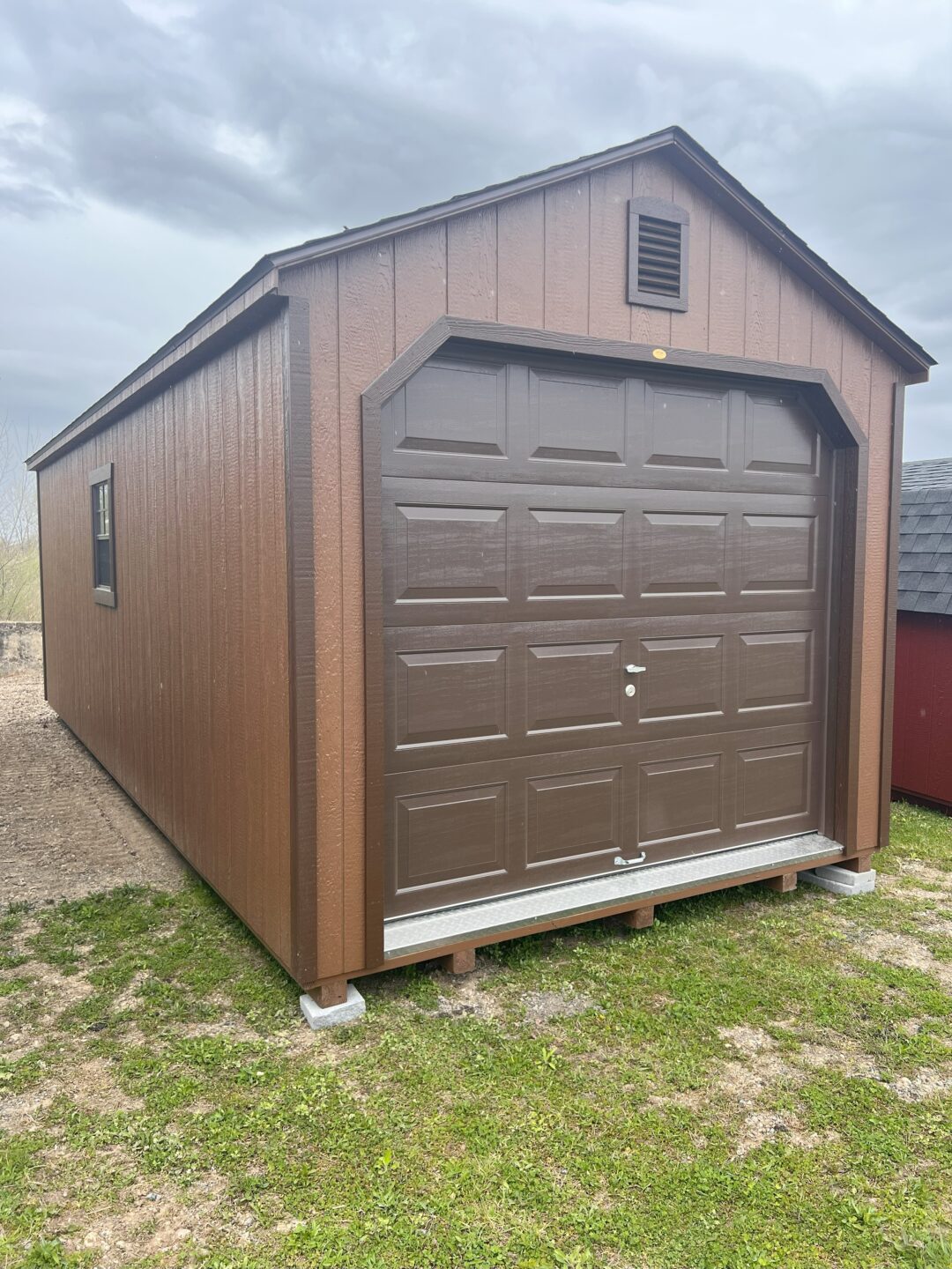 Chestnut garage with brown trim and brown overhead door