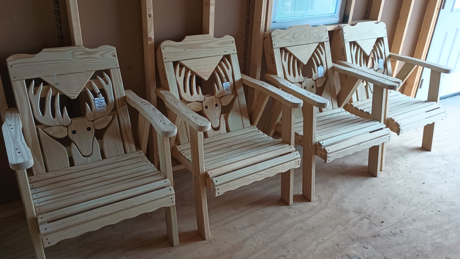 4 wooden chairs with deer head design