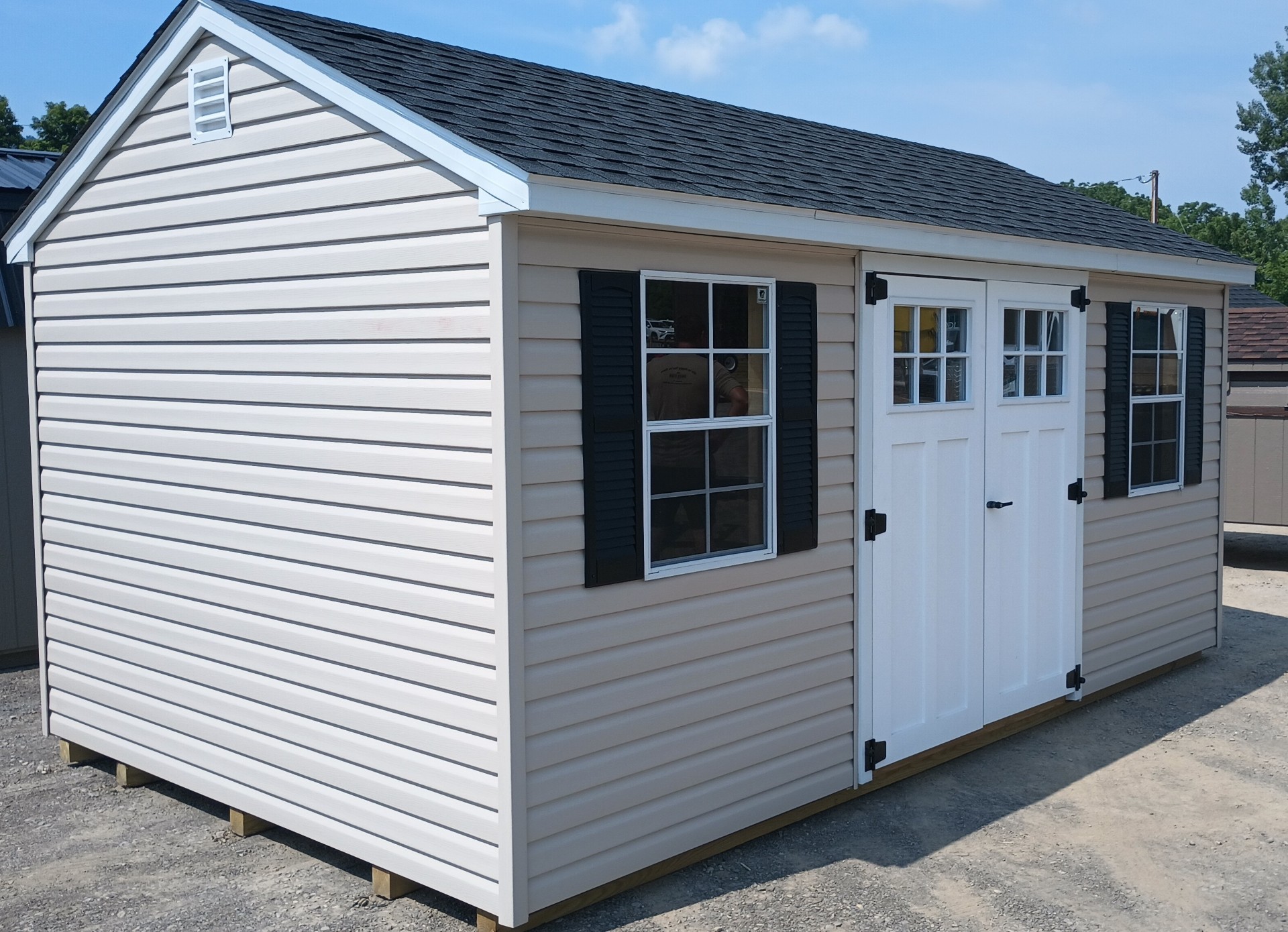 Vinyl shed with two windows, double doors and shingled roof