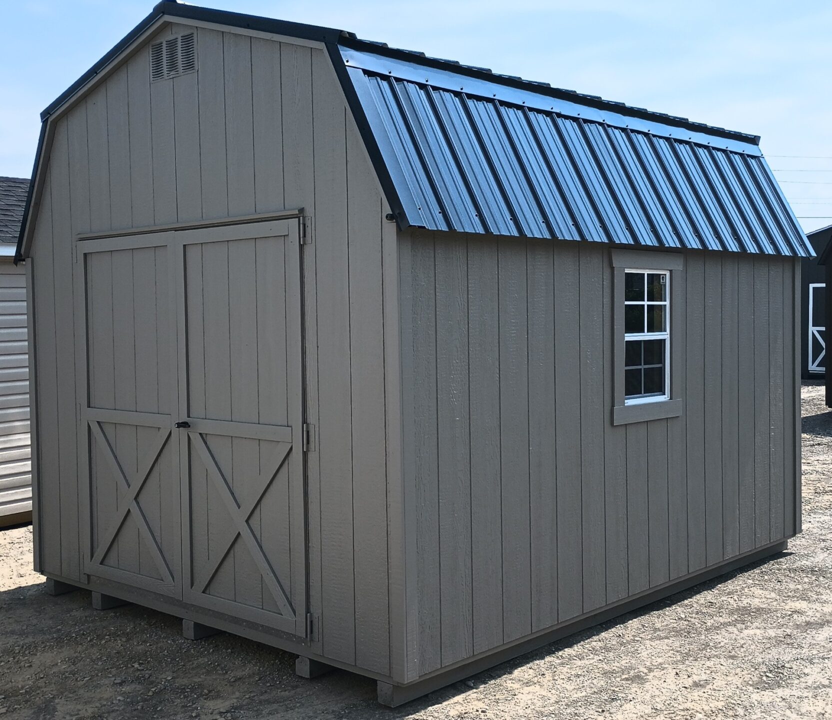 Barn style shed with oversized double doors, metal roof and 2 windows