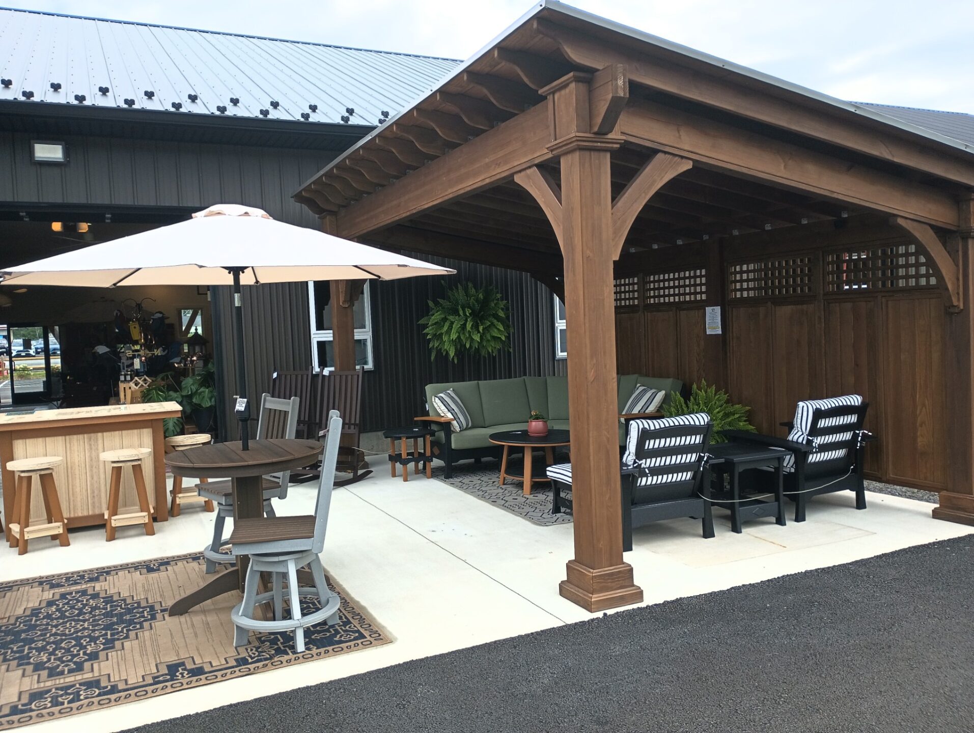 One slant pavilion with furniture underneath and privacy wall behind it