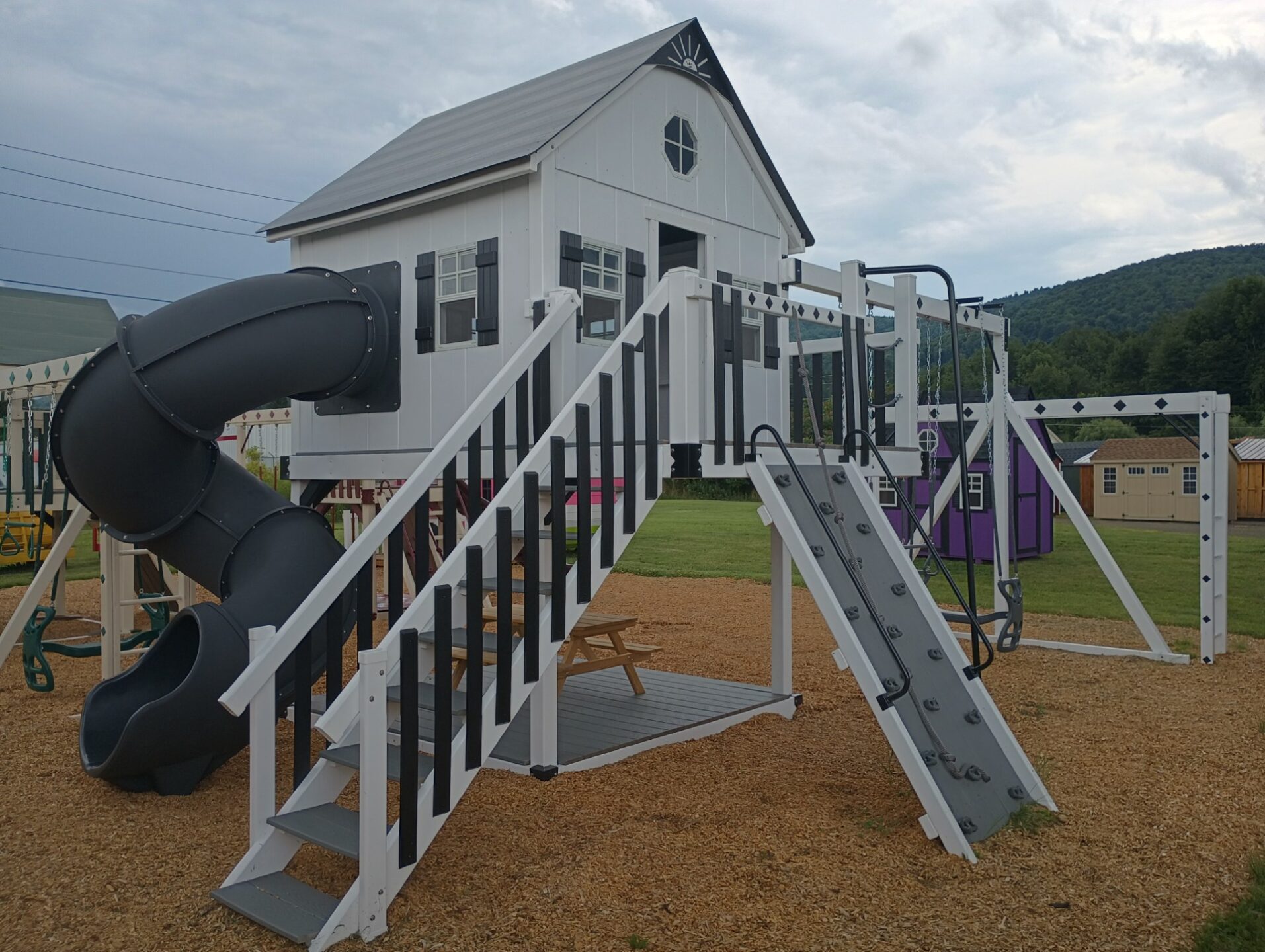 Large vinyl swing set with full playhouse, stairs, rock wall and tube slide