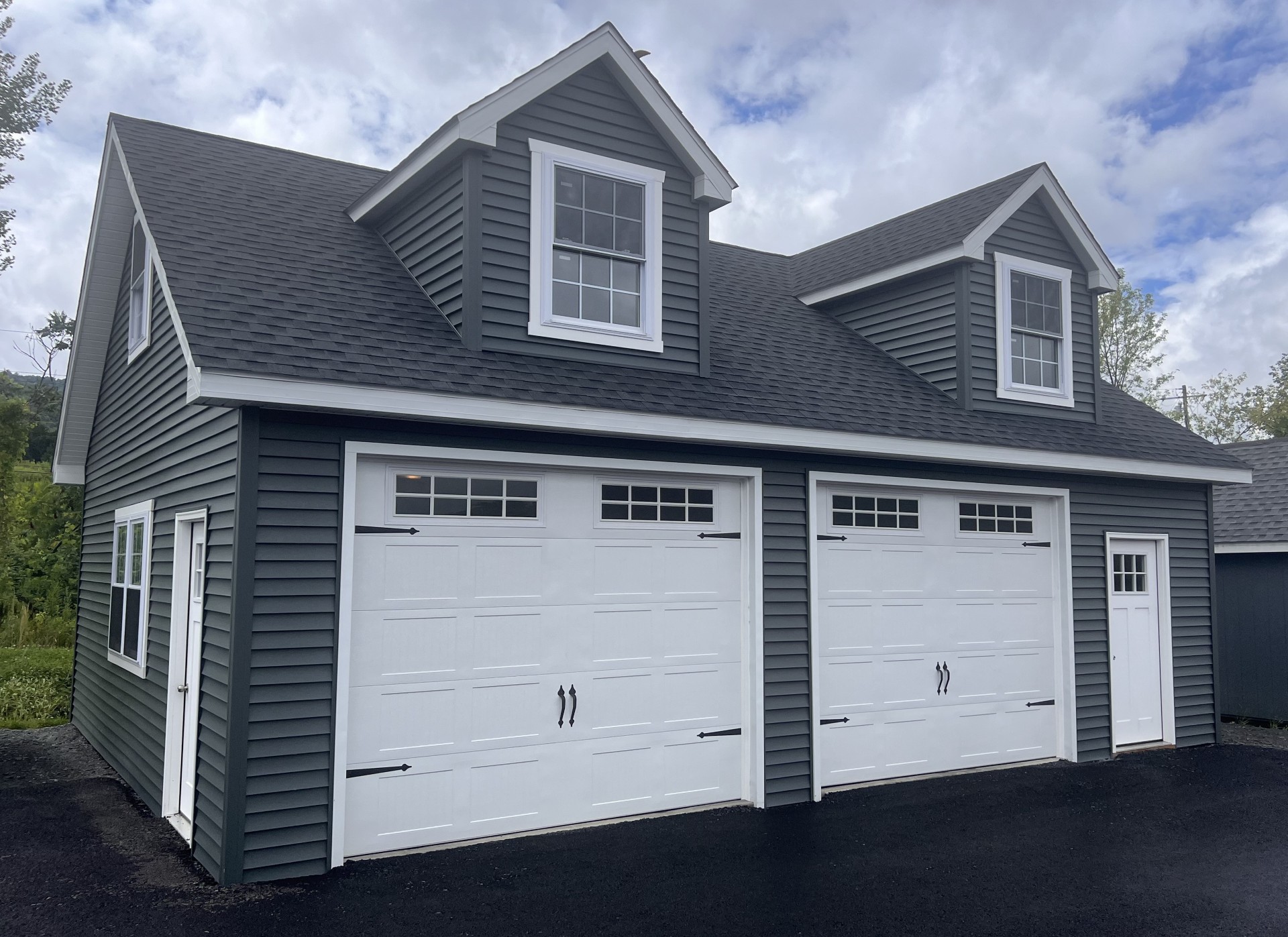Double garage with dormers, 2 entry doors and full second story