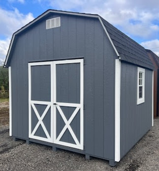 Dark gray shed with double doors, shingled roof and two windows